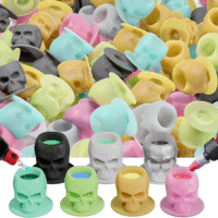 Silicone skull-shaped tattoo ink cups in vibrant colors, designed to protect needles and provide precision during tattooing.