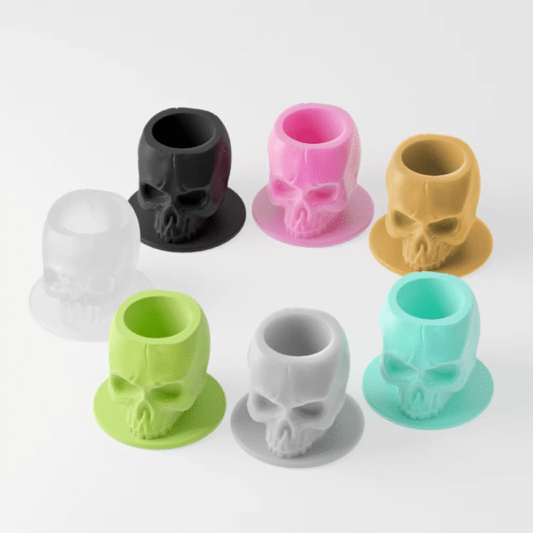 Silicone skull-shaped tattoo ink cups in vibrant colors, designed to protect needles and provide precision during tattooing.